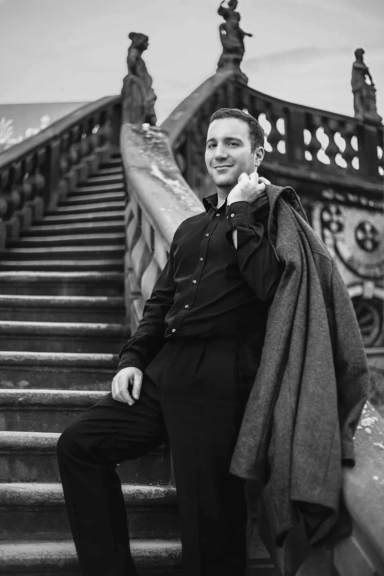 a black and white photo of a person standing on some stairs